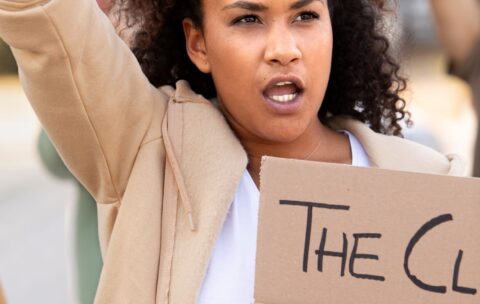 close-up-woman-holding-placard