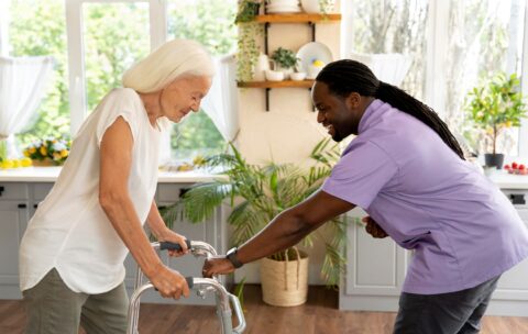 male-social-worker-taking-care-old-woman