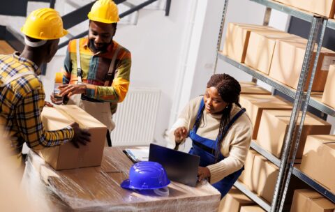 warehouse-manager-checking-orders-list-coordinating-parcels-packing-process-african-american-woman-supervisor-with-laptop-controlling-freight-cardboard-boxes-sealing-dispatching