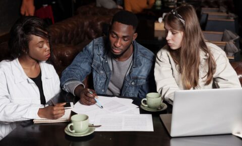 multiracial-friends-working-indoors